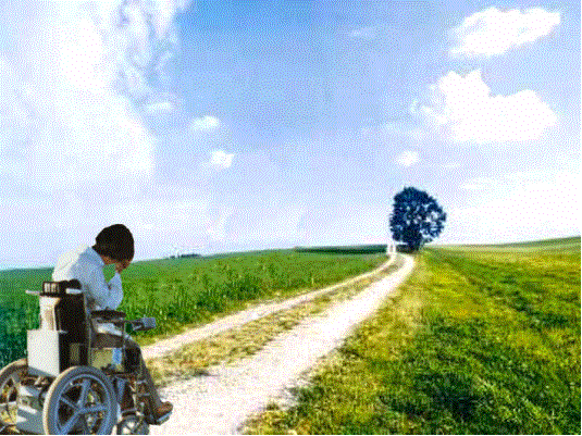 Young woman sitting in the wheelchair looking on the way